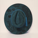 Dark green hat with floral patterns on a light beige background