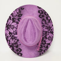 Purple hat with black floral pattern on a white background