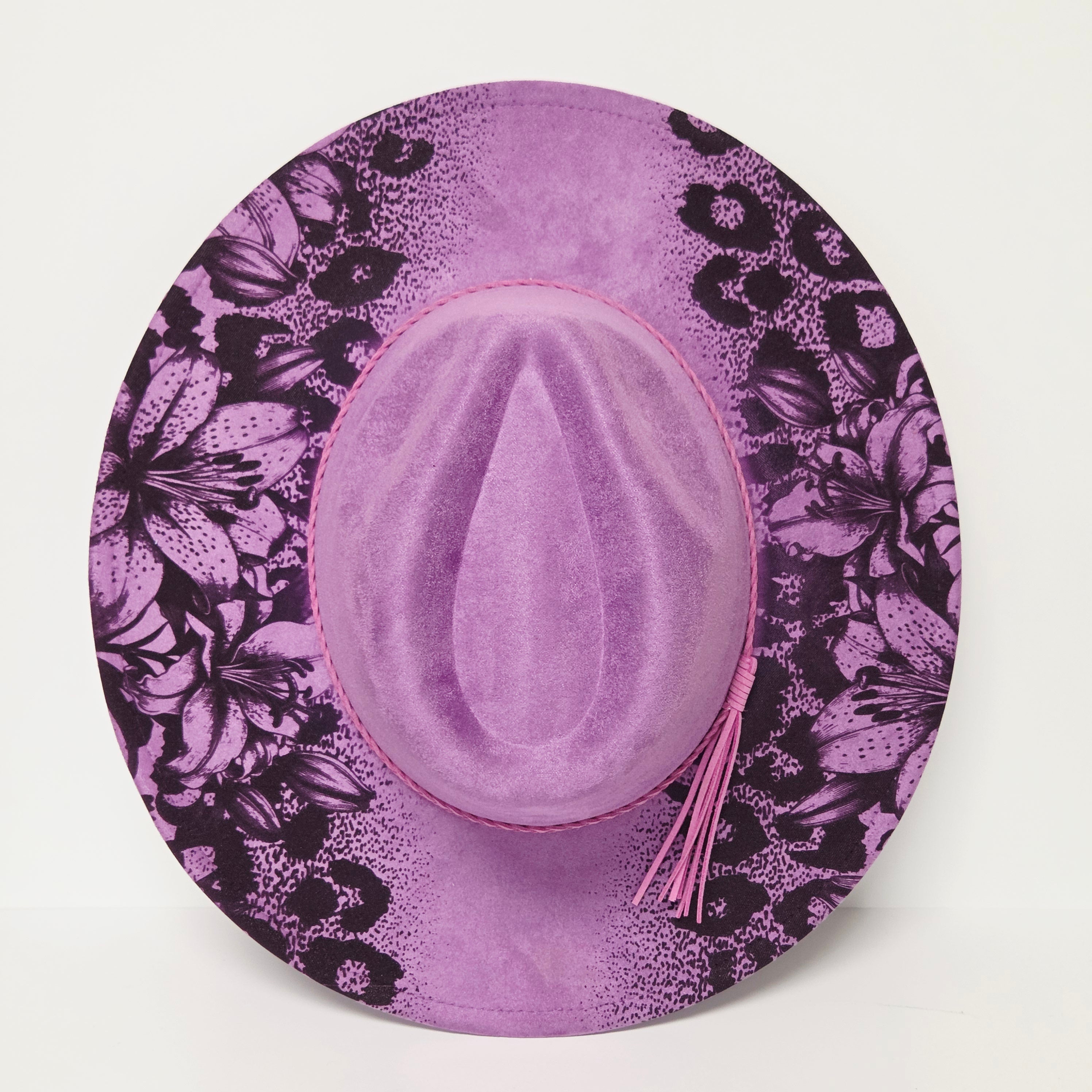Purple hat with black floral pattern on a white background