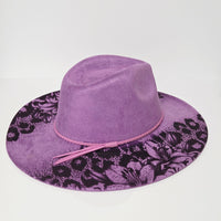 Purple velvet hat with floral pattern on a white background