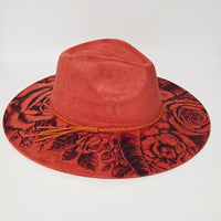 Red hat with floral pattern on a white background