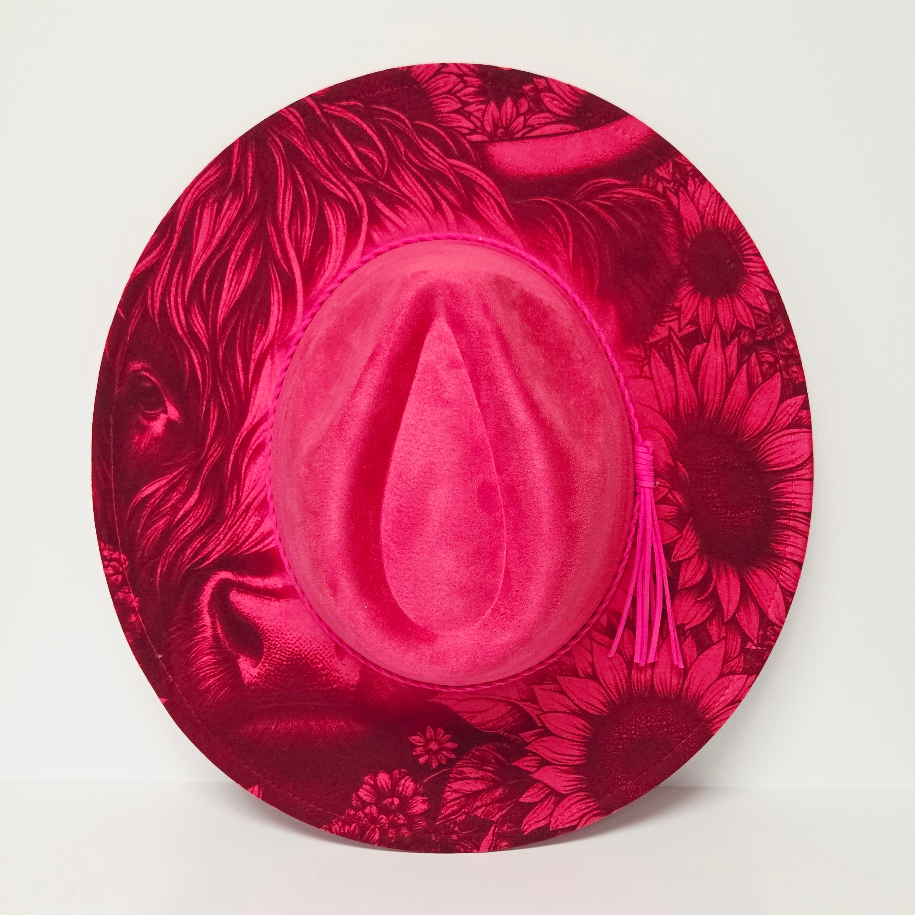 Pink hat with floral design on a white background