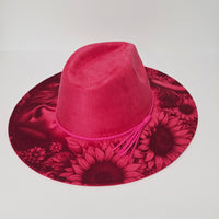 Pink hat with floral pattern on a light gray background