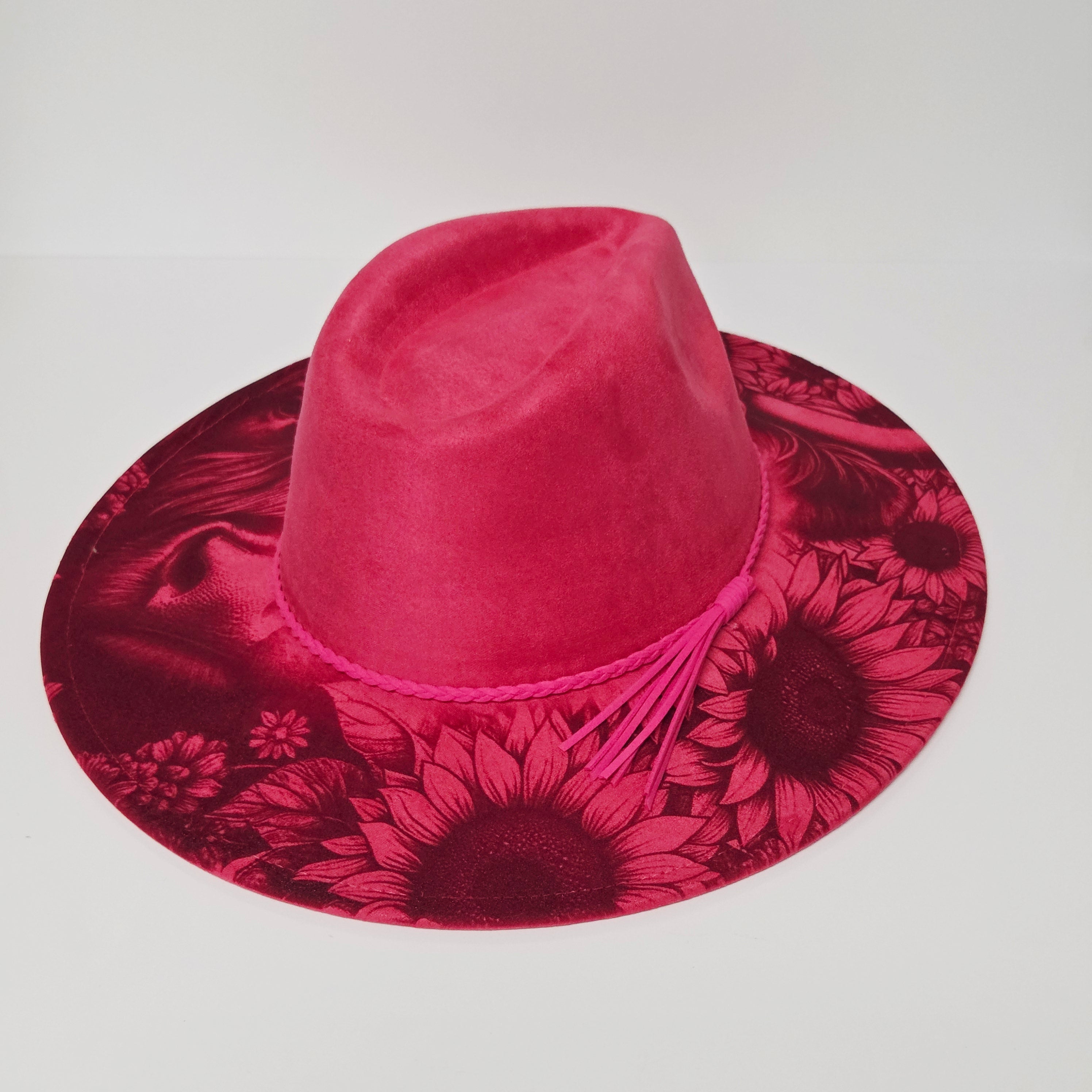 Pink hat with floral pattern on a light gray background