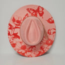 Pink hat with red floral and butterfly pattern on a light gray background