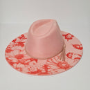 Pink hat with floral pattern on a light gray background