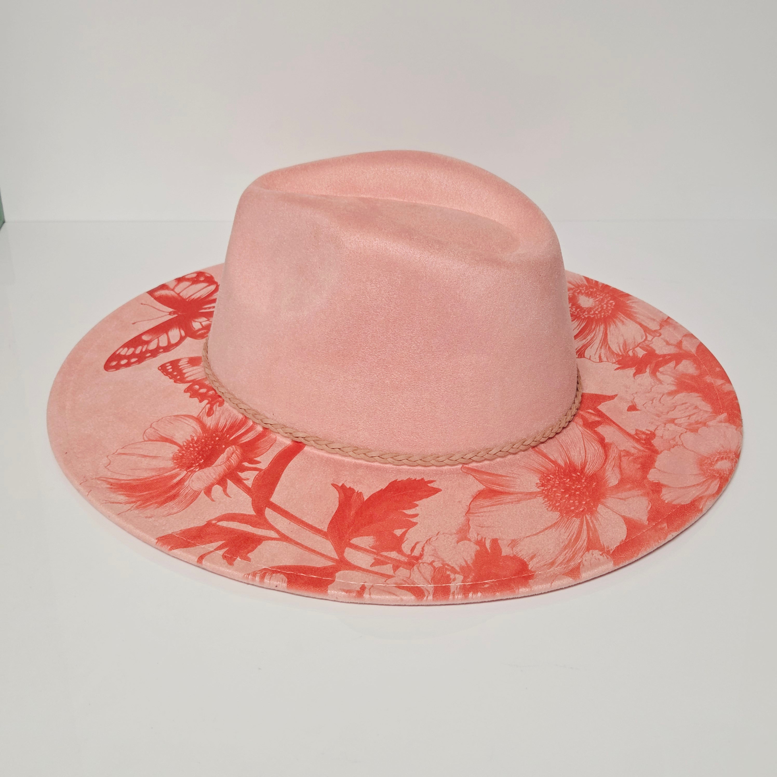 Pink hat with red floral pattern on a white background