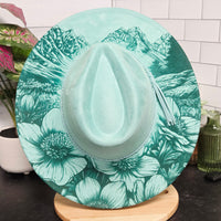 Green floral-patterned hat on a white surface