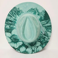 Round green plate with floral pattern on a white background