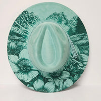 Green floral-patterned hat on a light gray background