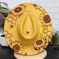 Yellow sunflower-patterned hat on a stand with a tiled wall background