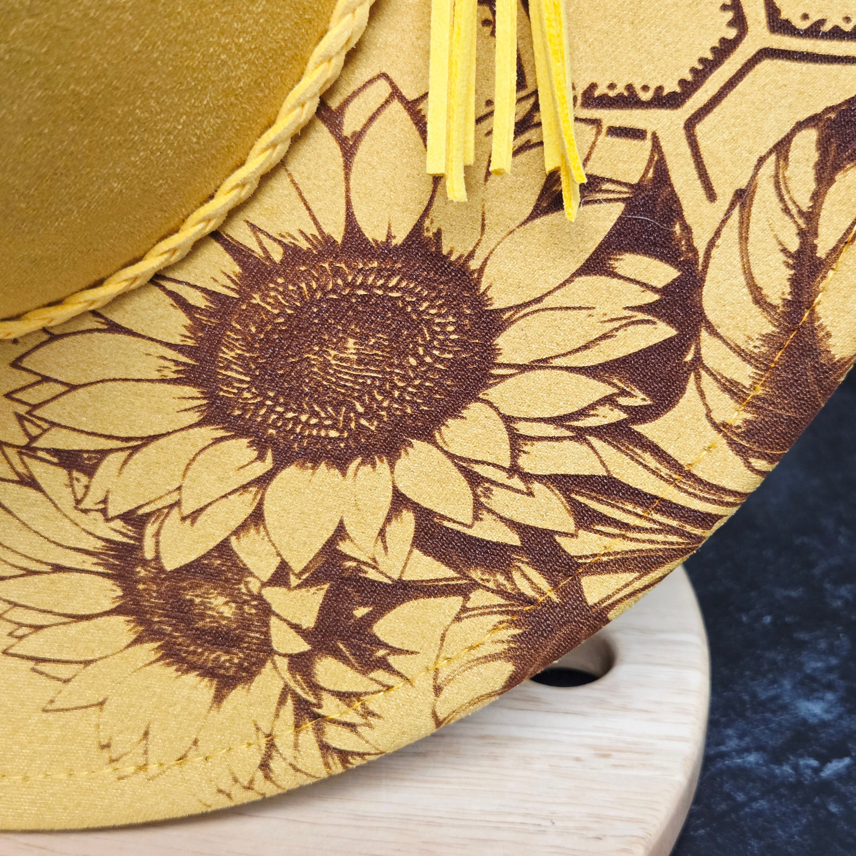 Close-up of a decorative item with sunflower patterns on a wooden surface.