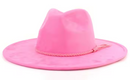 Pink cowboy hat with a braided band on a white background