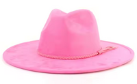 Pink cowboy hat with a braided band on a white background